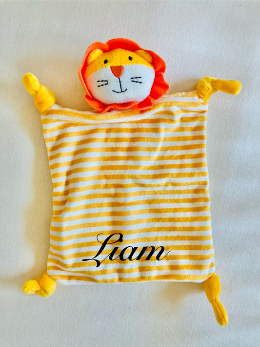 Personalized orange and yellow striped lion baby comforter with the name 'Liam' embroidered on it.